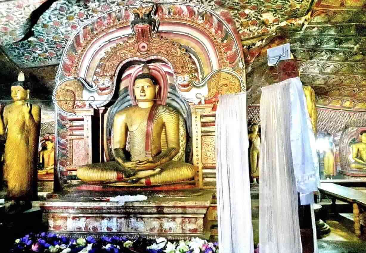 Sri Lanka, Dambulla Cave 3, a seating Buddha statue with Dragon Arch