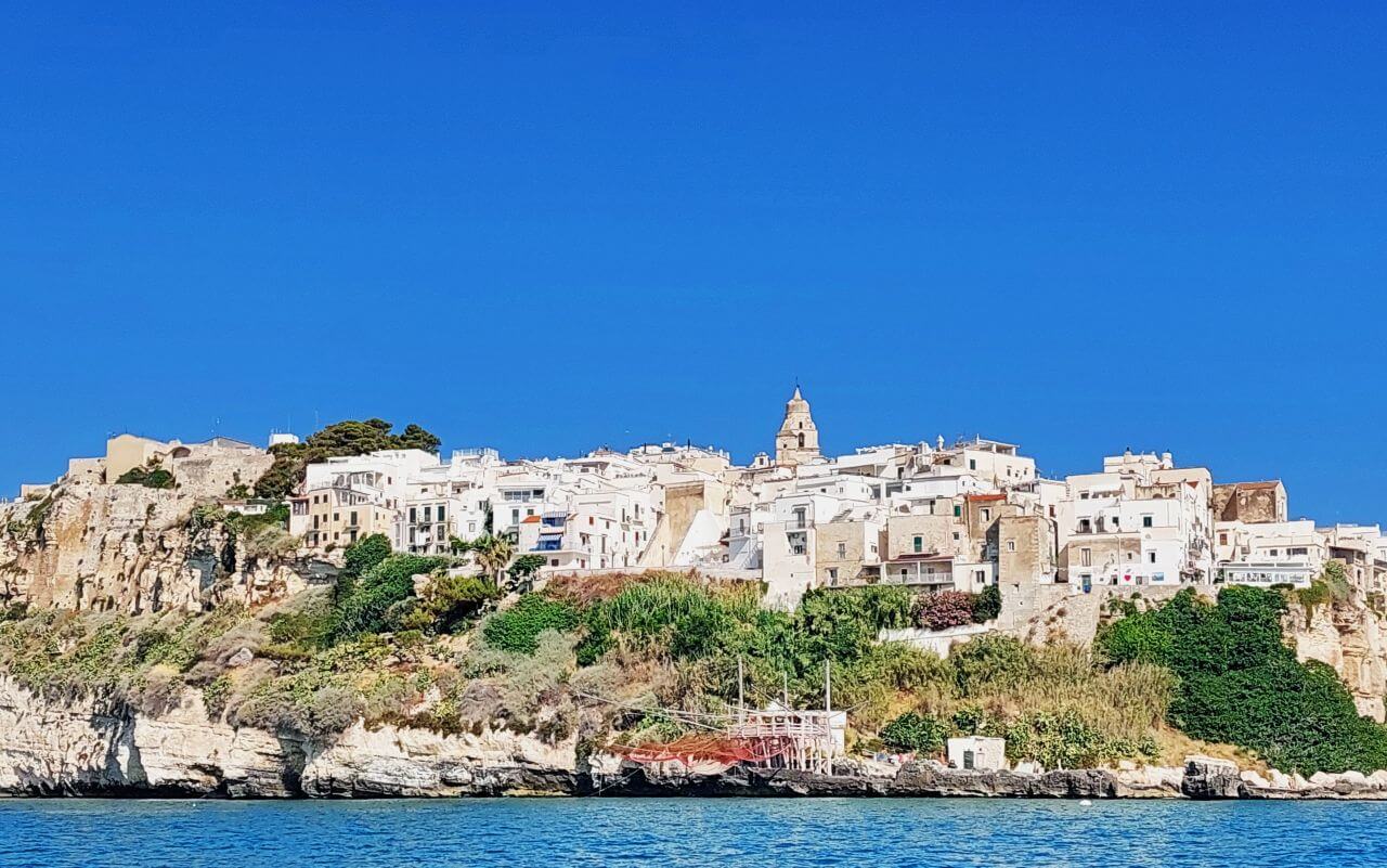 Puglia, a view of Vieste Old Town and a trabucco from the sea