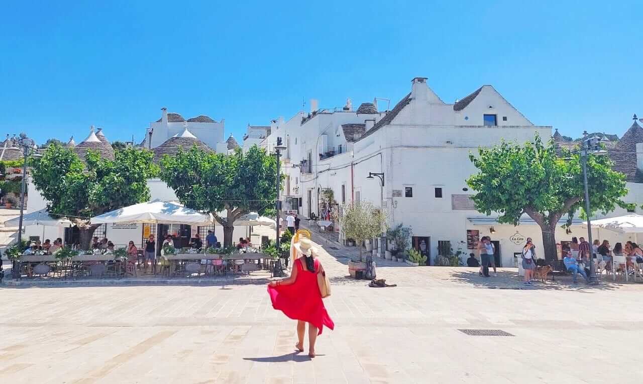 Alberobello, locals around the Largo Martellotta, Puglia, Italy